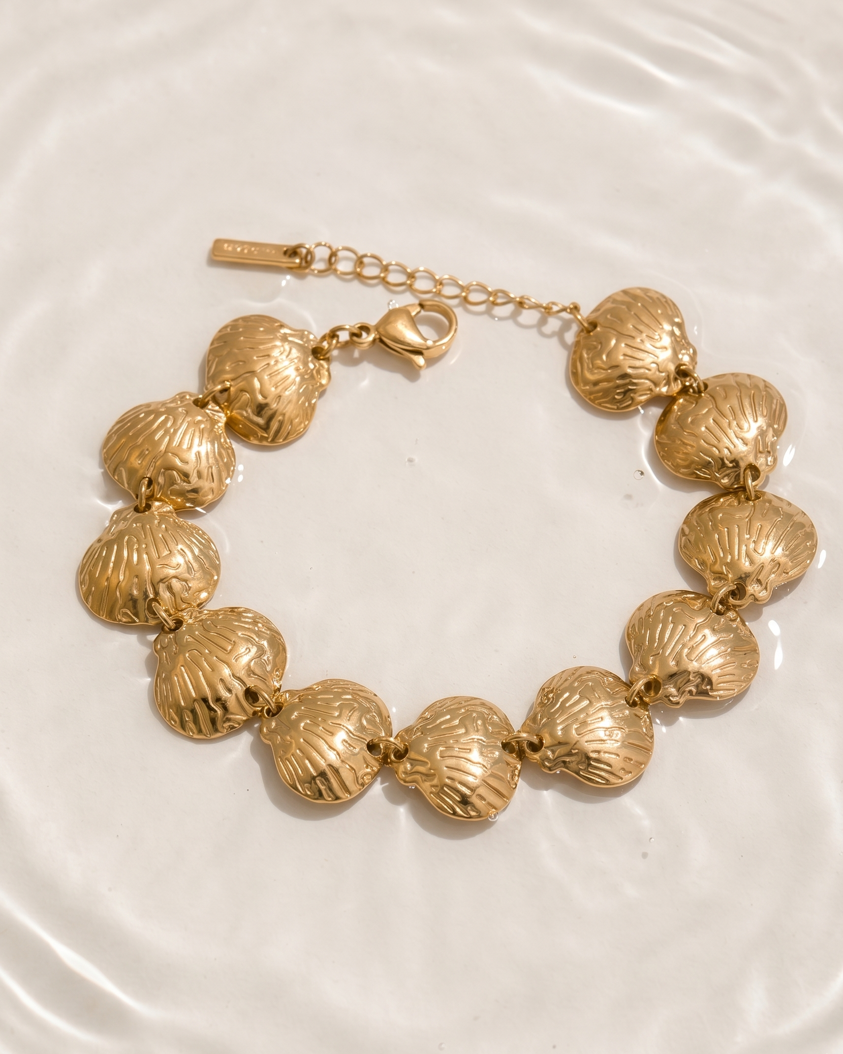 Gold bracelet on a white plate