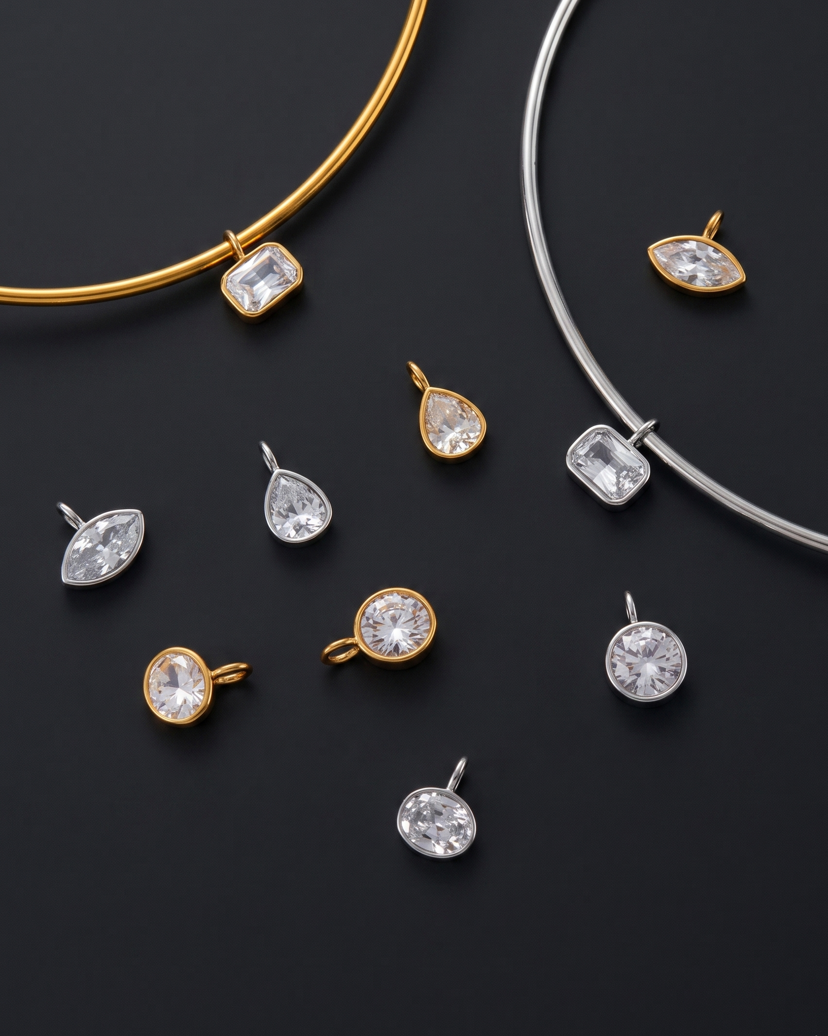 Jewelry set with gold and silver necklaces and various pendants on a dark background
