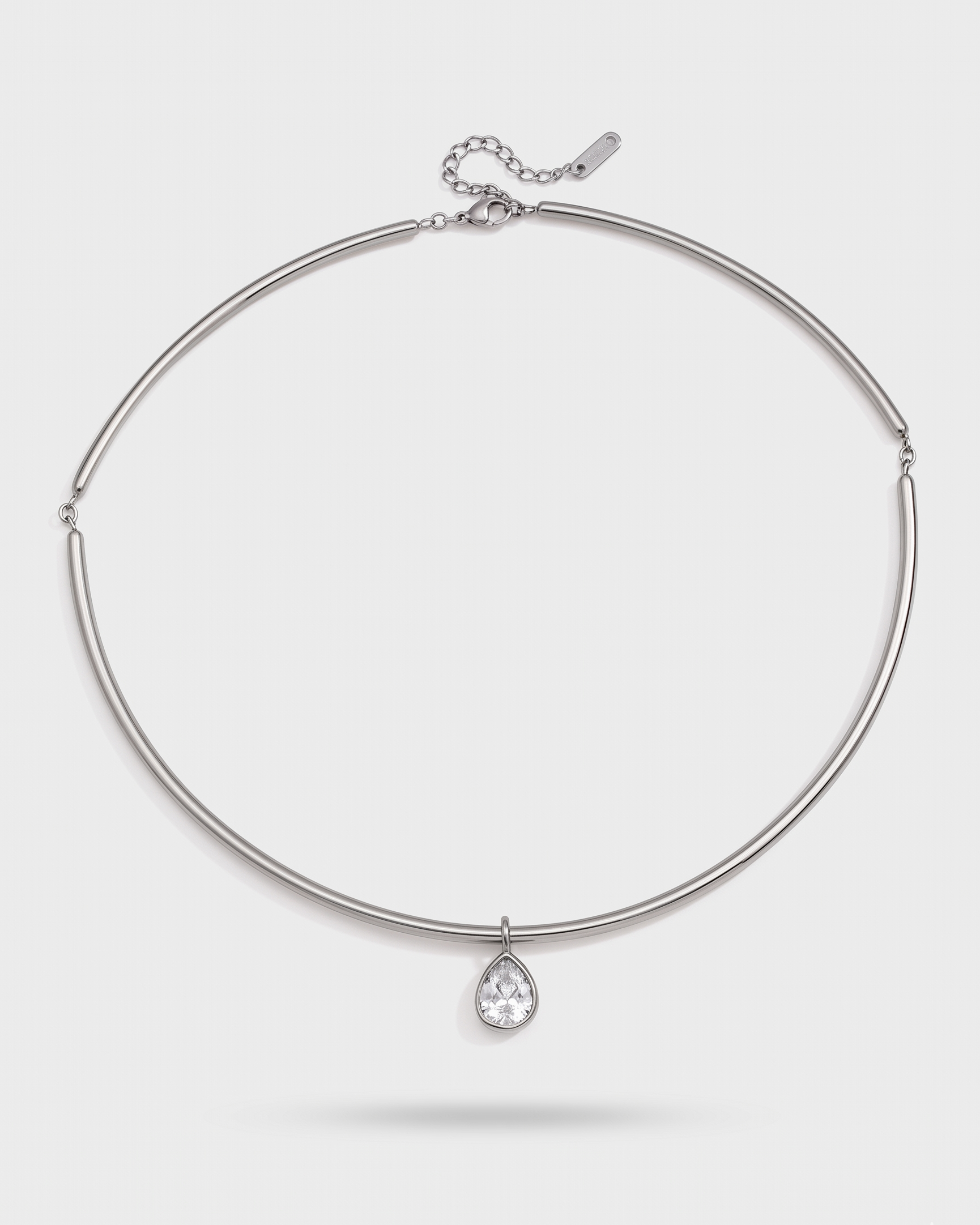Silver necklace with a teardrop-shaped pendant on a white background