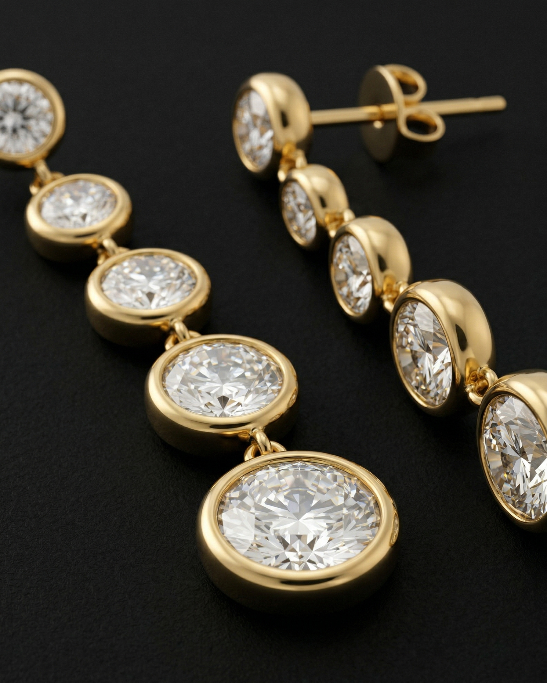 Gold and diamond earrings on a black background