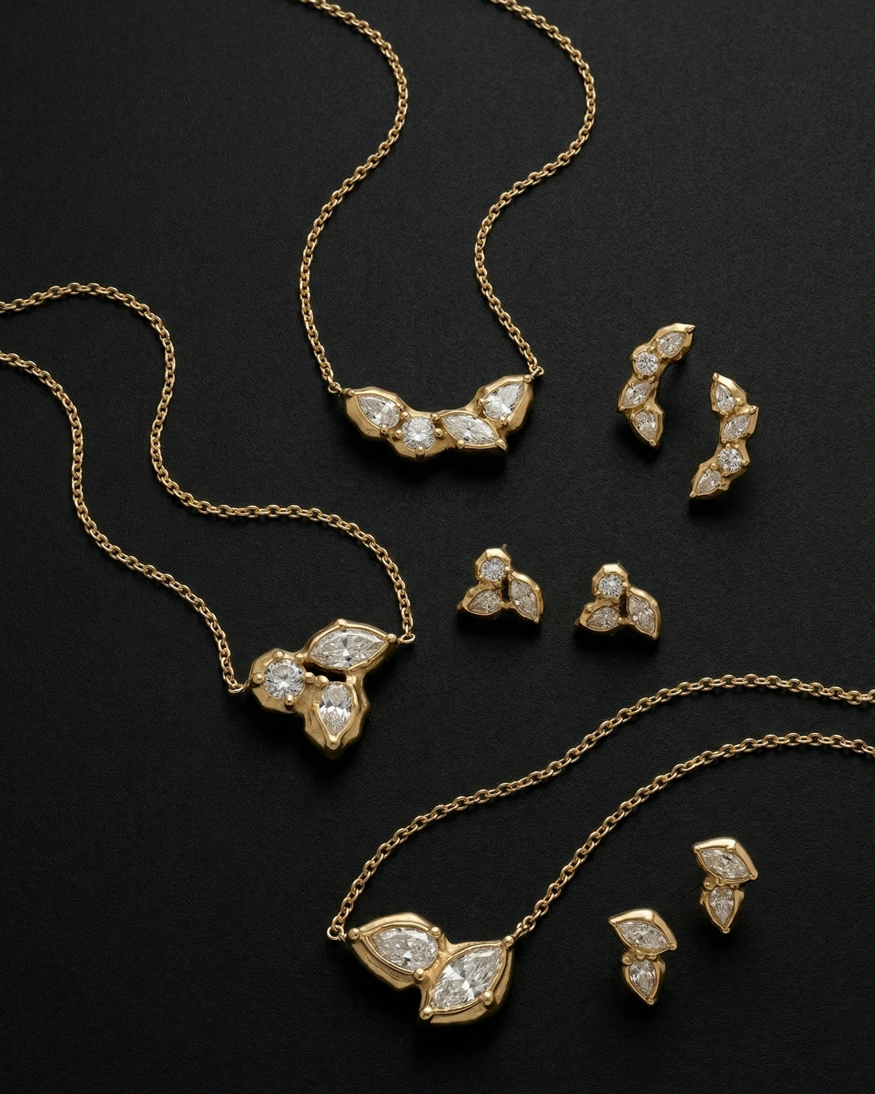 Gold jewelry set with necklaces and earrings on a black background