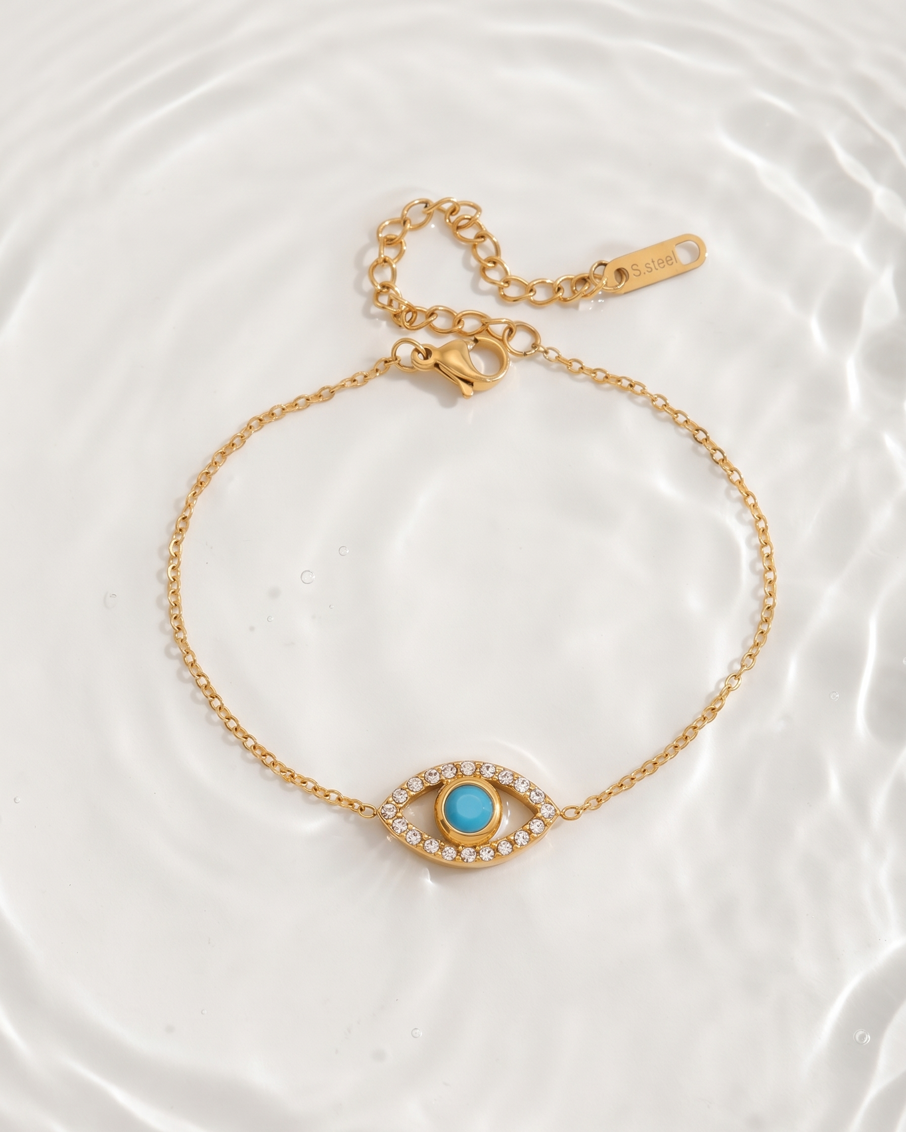 Gold bracelet with a turquoise stone on a white background
