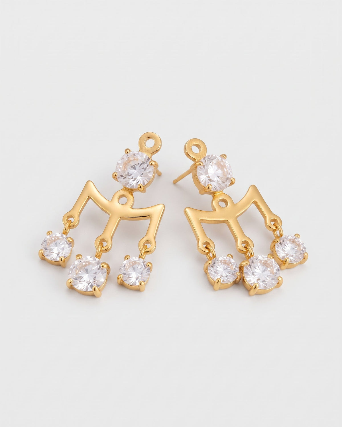 A pair of gold-tone drop earrings featuring a stylized arch design with clear round-cut rhinestones, displayed on a light gray background.